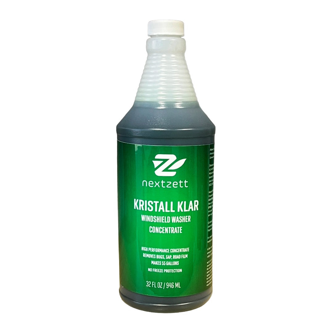A 32 fl oz bottle of Nextzett Kristall Klar Windshield Washer Concentrate, featuring a green label and white cap, on a white background.