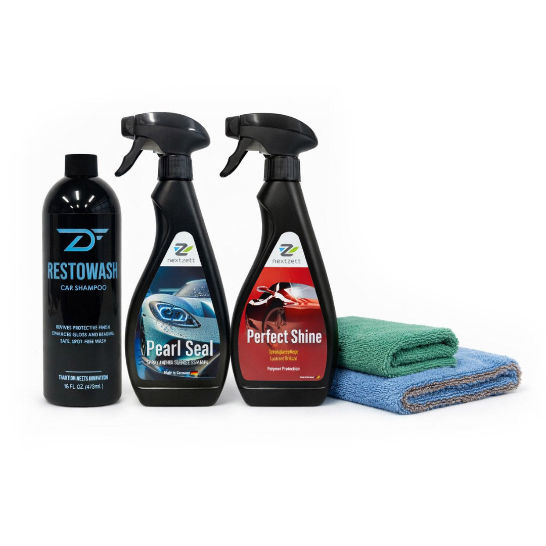 Set of car care products including bottles and cloths on a white background
