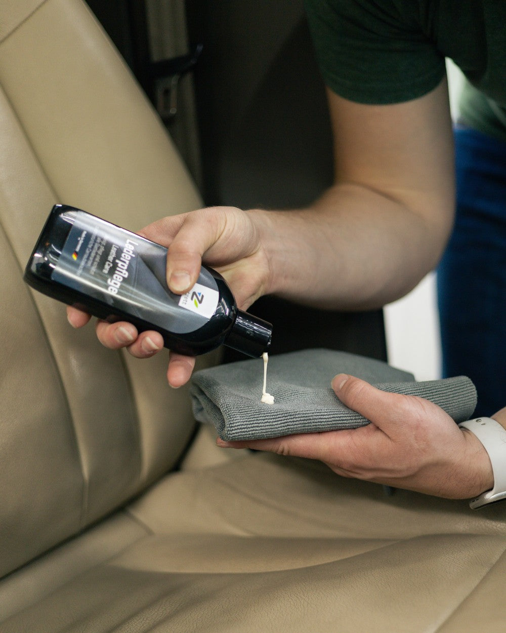 Person applying nextzett Leather Care to a car seat with a cloth