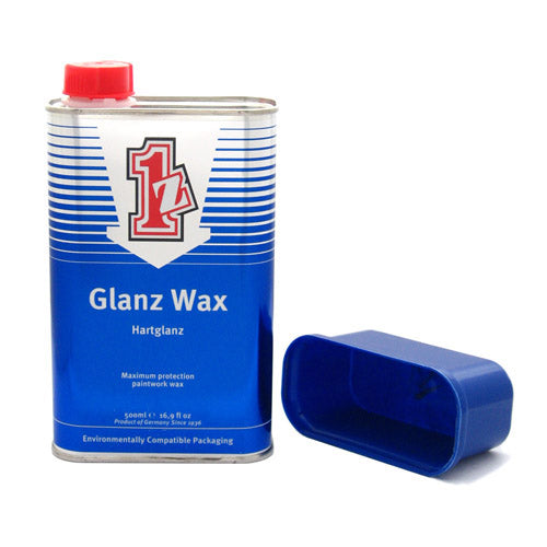 A 500ml metal can of  1z einszett Hartglanz Glanz Wax with a blue and white label and a red cap, shown next to its blue plastic lid on a white background.