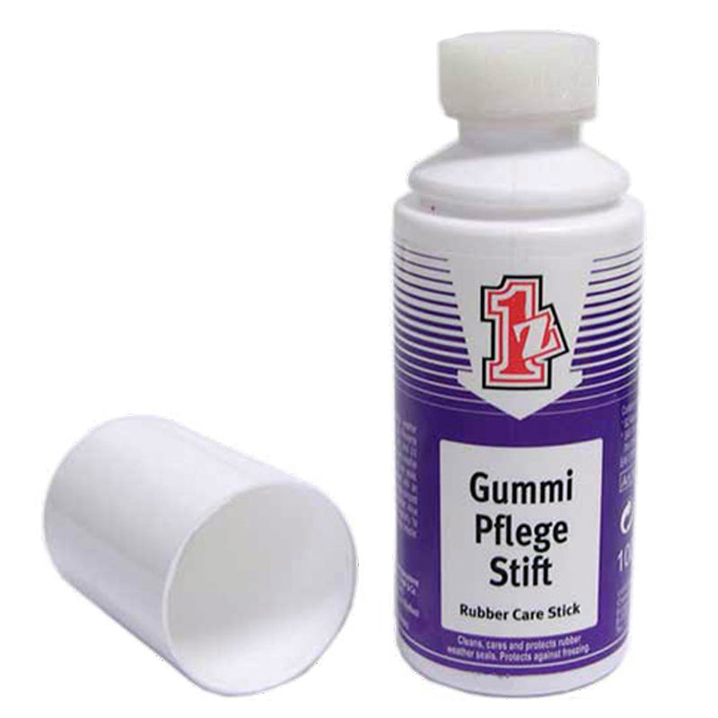 A white plastic bottle of 1z einszett Gummi Pflege Stift rubber care stick with a purple label and a detached white cap placed beside it on a white background.