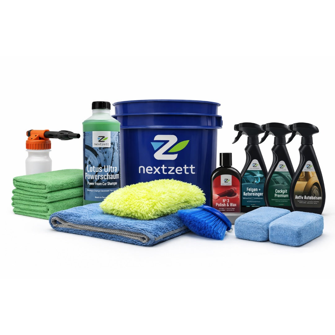 Car care products including a blue bucket, bottles, cloths, and a spray bottle on a white background with 'nextzett' branding.