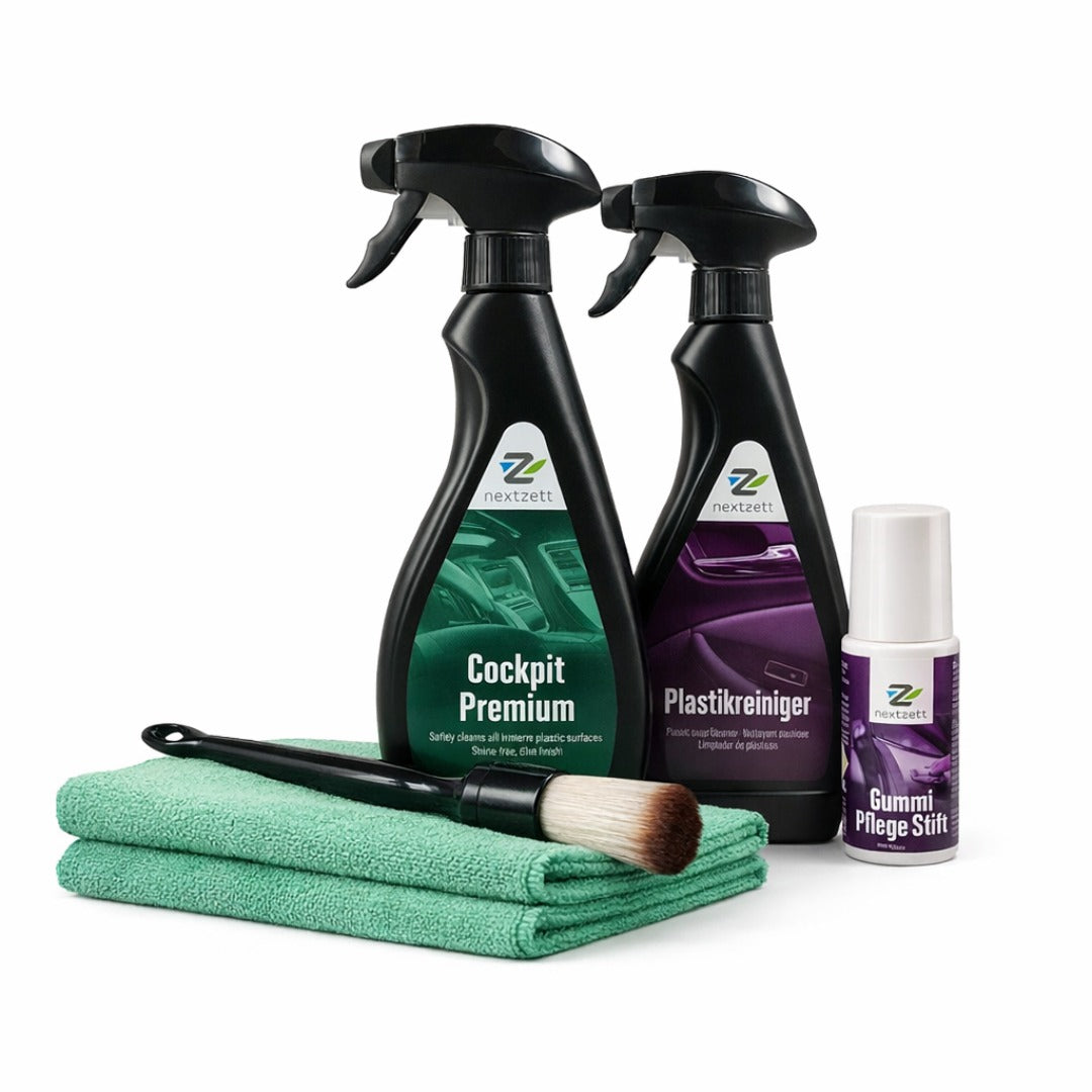 Car cleaning products including sprays, a brush, and cloths on a white background
