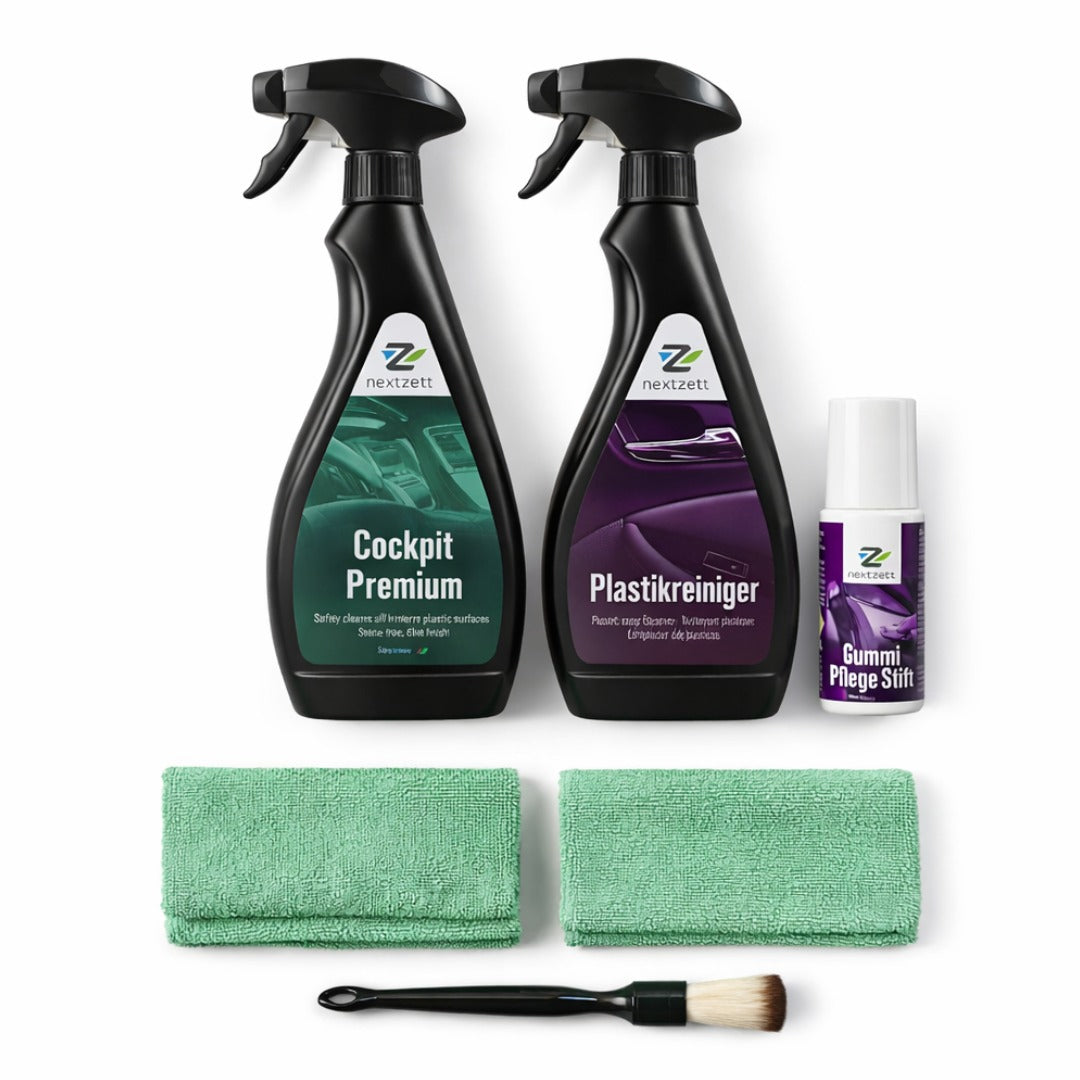 Automotive care products including spray bottles, cloths, and a brush on a white background