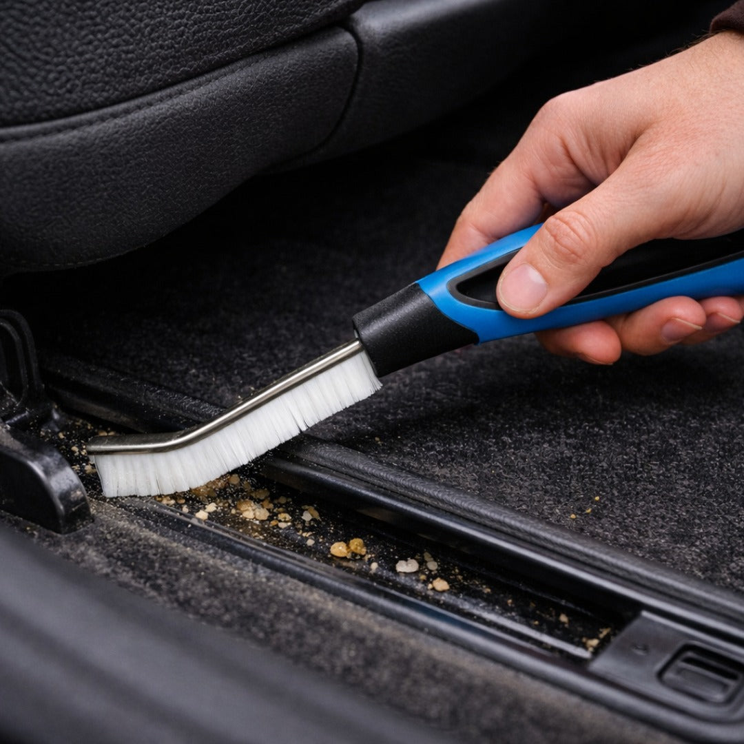 Person cleaning car interior with a brush