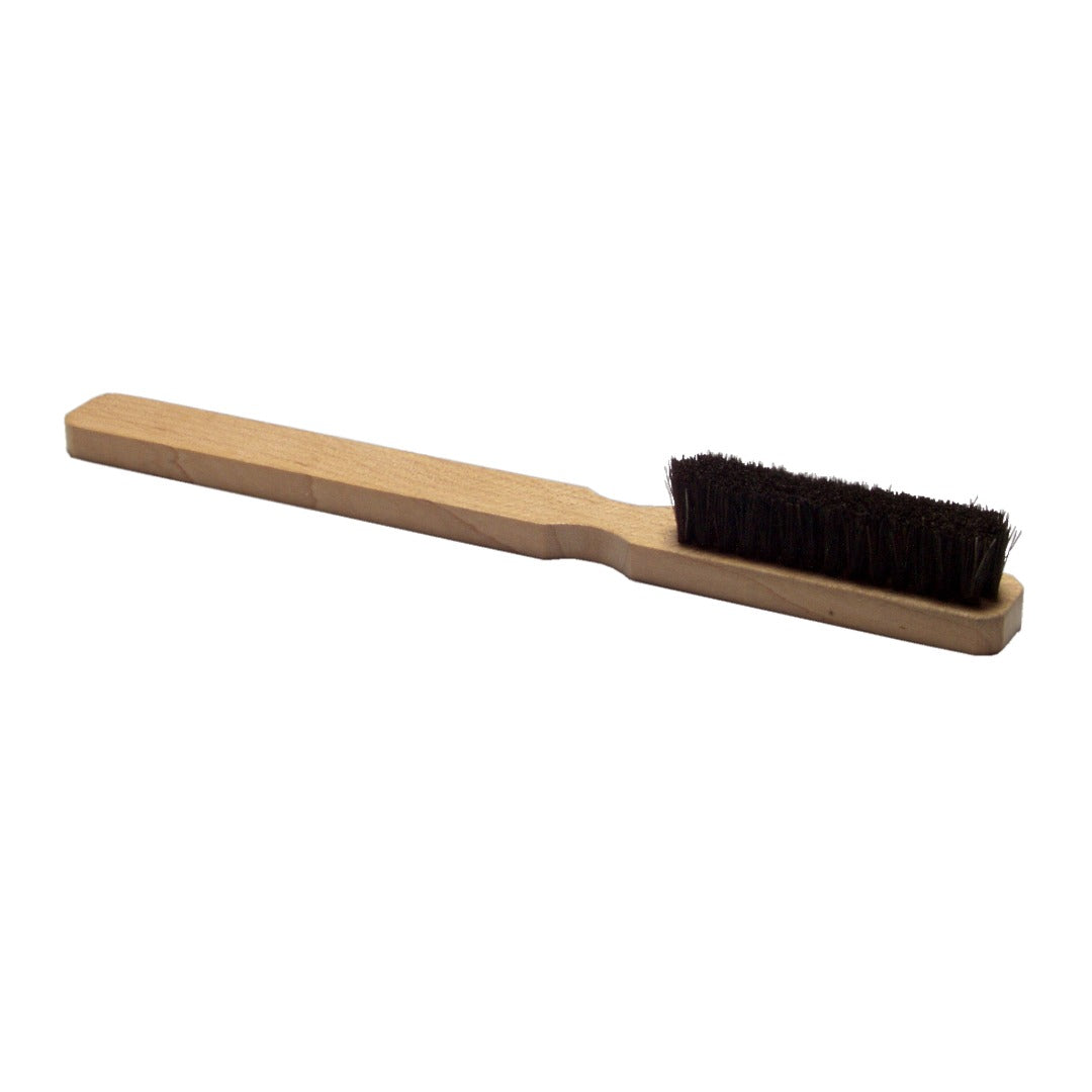 Wooden brush with black bristles on a white background